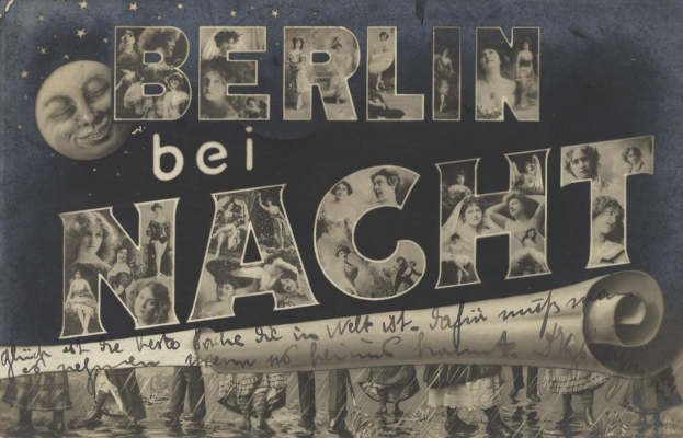 Schwarzes und weißes Foto einer Gruppe von Menschen, die vor einem "Berlin Bei Nacht"-Schild mit einem Mond im Hintergrund feiern, das Schild zeigt ein Stern- und Streifenmuster.