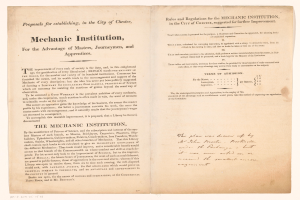 Ein aufgeschlagenes Buch mit der Aufschrift 'Mechanic Institution, for the Advantage of Masters, Journeymen, and Apprenticeships' auf der Seite.